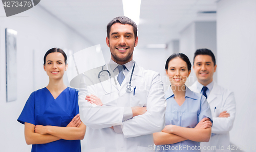 Image of happy group of medics or doctors at hospital