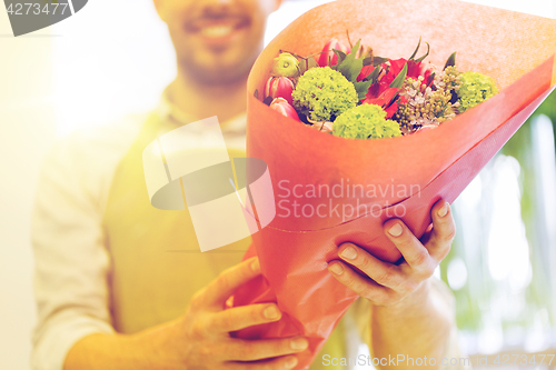 Image of close up of florist with bunch at flower shop