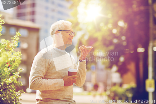 Image of old man using voice command recorder on smartphone