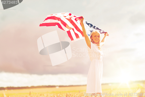 Image of happy woman with american flag on cereal field