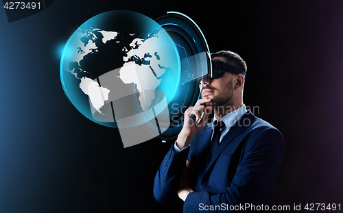 Image of businessman in virtual reality headset over black