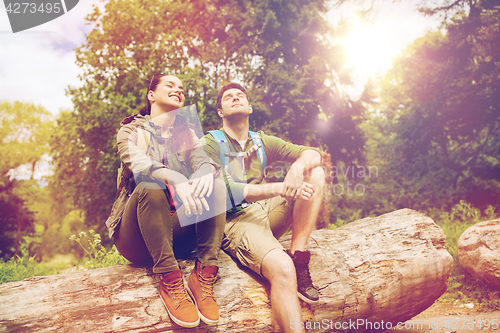 Image of smiling couple with backpacks in nature