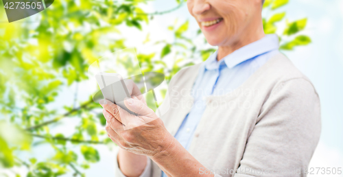 Image of close up of senior woman with smartphone texting
