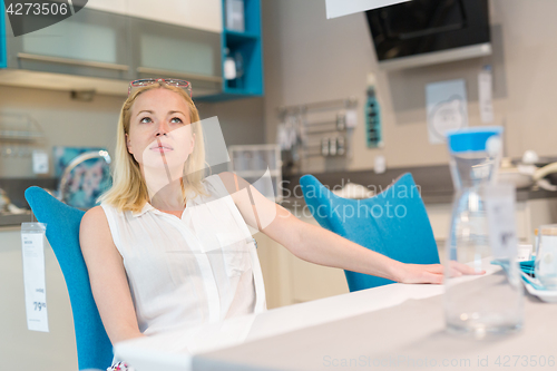 Image of Woman shopping for furniture, sofa and home decor in store.