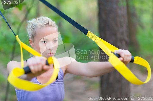 Image of Training with fitness straps outdoors.