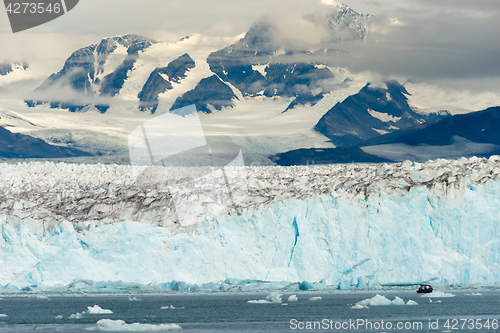 Image of Boat Dwarfed by Mountains Glaciers Alaska Kenia Fjords 