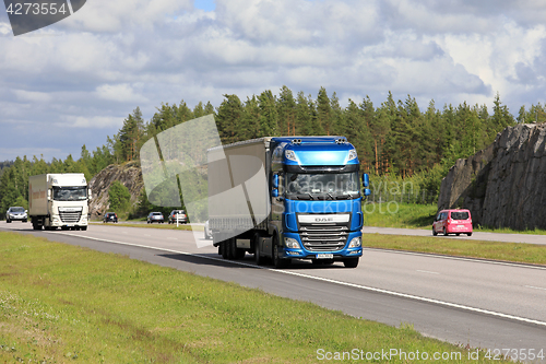 Image of DAF Semi Trucks Transport Merchandise among Traffic