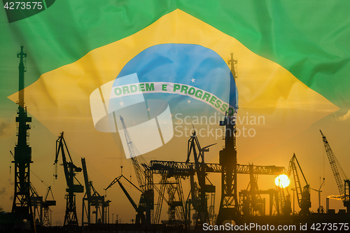 Image of Industrial concept with Brazil flag at sunset