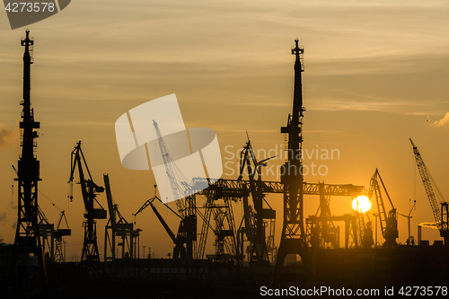 Image of Silhouette of container harbor in Hamburg at sunset