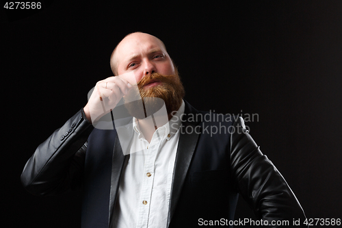 Image of Man twirling his ginger mustaches