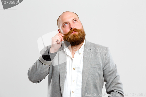 Image of Thoughtful man with beard , mustache