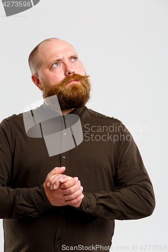 Image of Pensive man in brown shirt