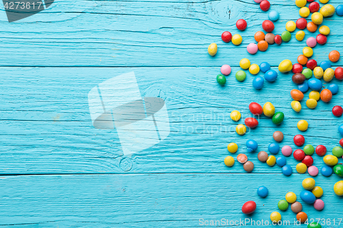 Image of Multicolored candy on wooden table