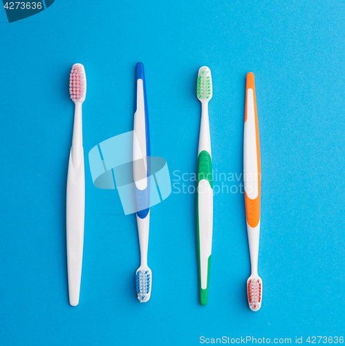 Image of Multicolored toothbrushes on blue background