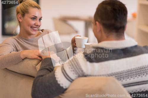 Image of Young couple  in front of fireplace