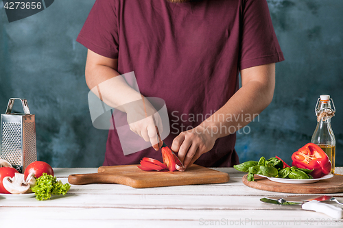 Image of Closeup hand of chef baker making pizza at kitchen