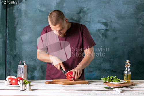 Image of Closeup hand of chef baker making pizza at kitchen