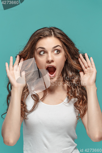 Image of Portrait of young woman with shocked facial expression