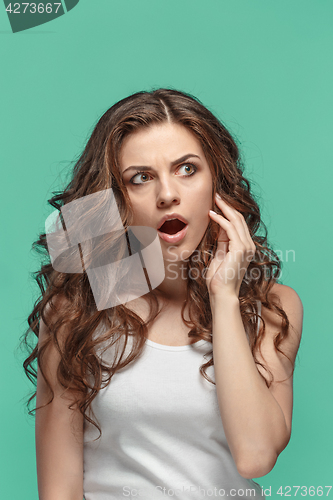 Image of Portrait of young woman with shocked facial expression