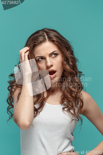 Image of Portrait of young woman with shocked facial expression