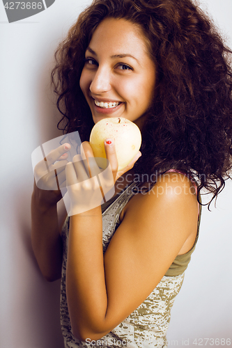 Image of pretty young real tenage girl eating apple close up smiling