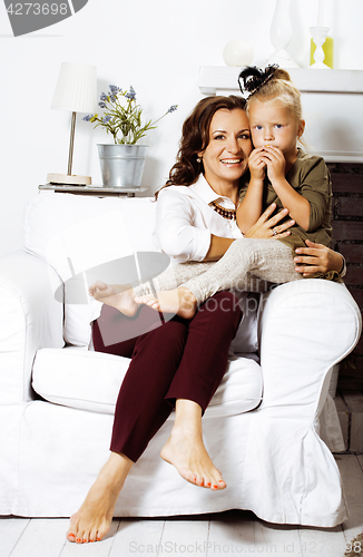 Image of happy smiling mother with little cute daughter at home interior,