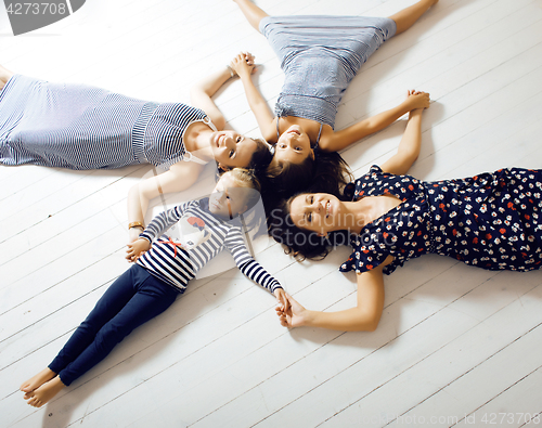 Image of Mature sisters twins at home with little daughter, happy family 