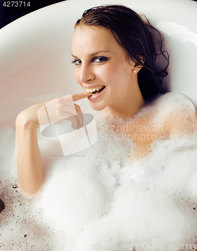 Image of young cute sweet brunette woman taking bath, happy smiling people concept
