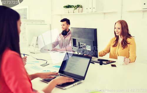 Image of creative team with computers working at office