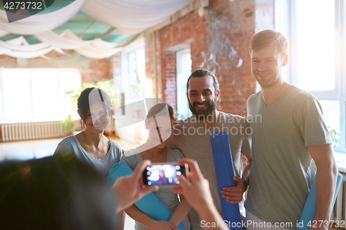 Image of happy people at yoga studio or gym photographing
