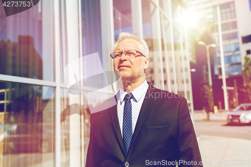 Image of senior businessman on city street
