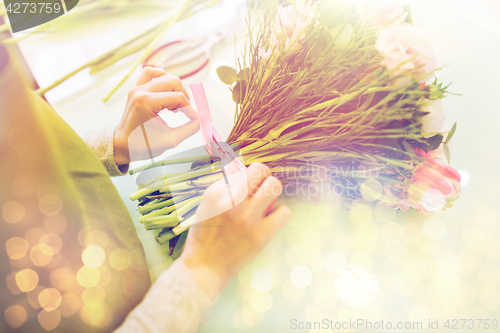 Image of close up of woman making bunch at flower shop