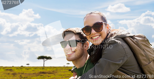 Image of happy couple with backpacks traveling in africa