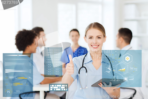 Image of doctor with tablet pc at clinic showing thumbs up