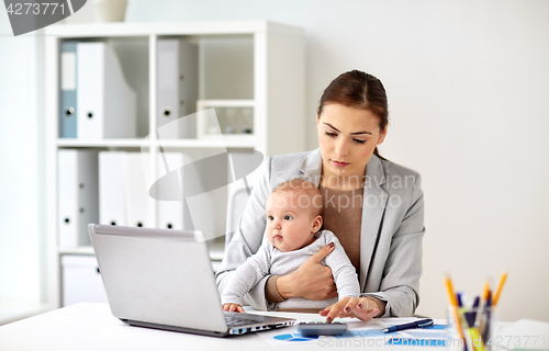 Image of businesswoman with baby working at office