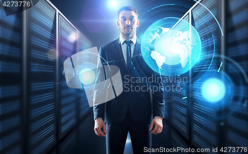 Image of businessman with world map projection in corridor
