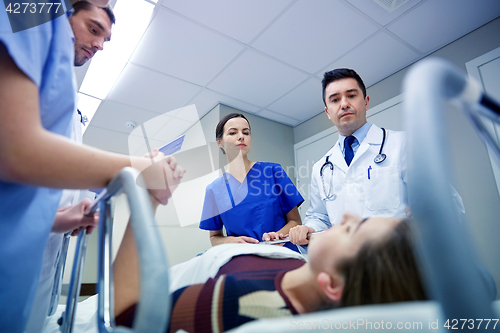 Image of medics and patient on hospital gurney at emergency