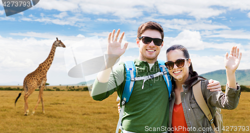 Image of smiling couple with backpacks traveling in africa