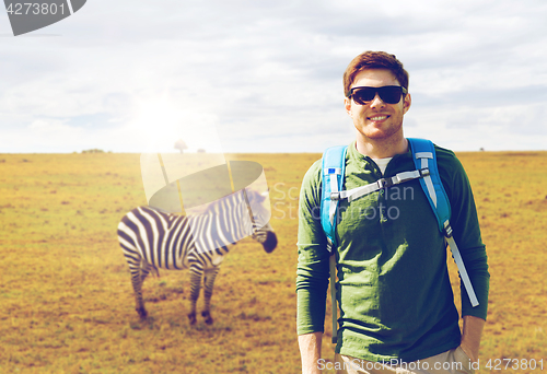 Image of happy young man with backpack traveling in africa