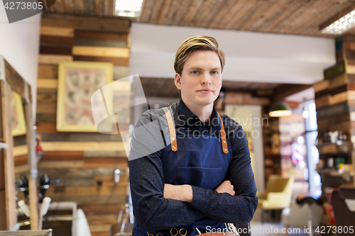 Image of male hairdresser at hair salon or barbershop