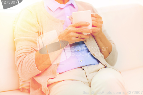 Image of close up of senior woman with tea  cup at home