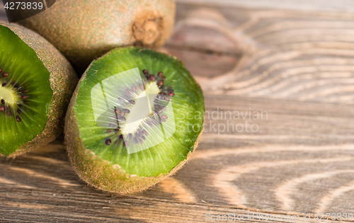 Image of Whole Food Fruit Green Kiwi Halves Seeds Cutting Board