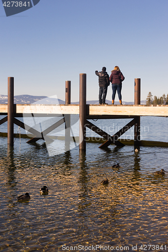 Image of Two people sight see off dock Lake Tahoe