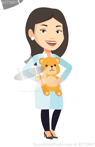 Image of Pediatrician doctor holding teddy bear.