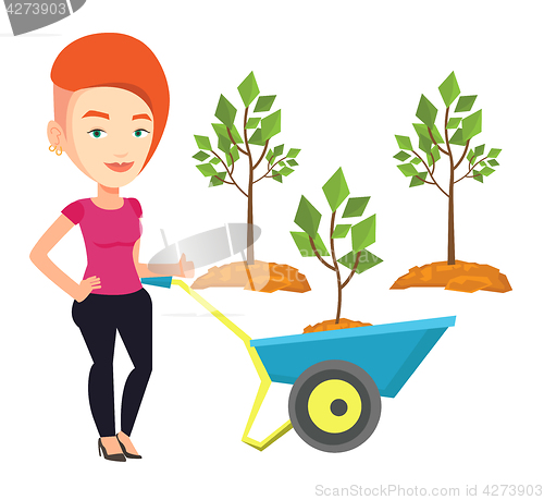 Image of Woman pushing wheelbarrow with plant.