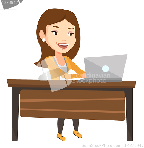 Image of Office worker working on laptop at workplace.