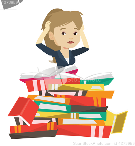 Image of Student sitting in huge pile of books.