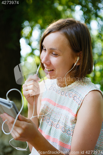 Image of Laughing woman talking phone