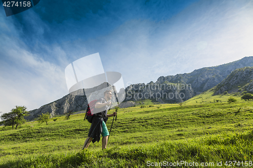 Image of Man Hiking in Green Mountains