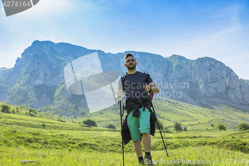 Image of Man Hiking in Green Mountains